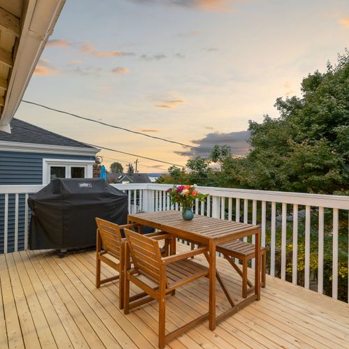 Upper deck with outdoor sofa and sunset views — the perfect place for wine and conversation.