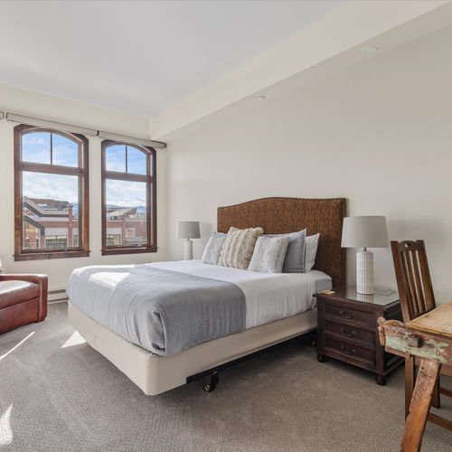 Bedroom 1 with king bed and chair that converts to twin bed