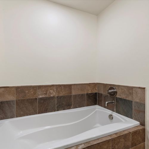 Soaking tub in en suite bathroom