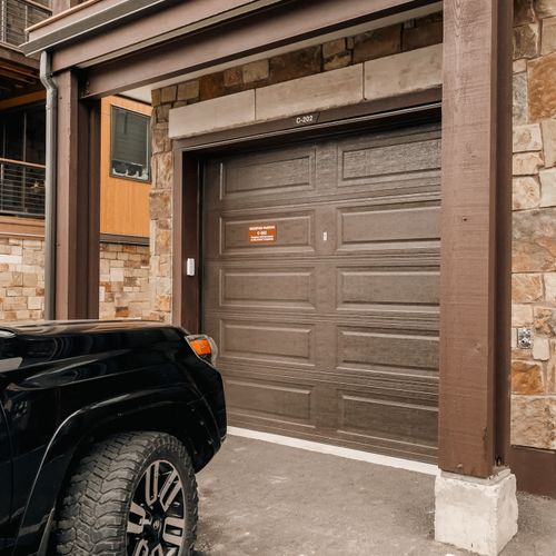Designated parking for 1 small to medium vehicle in the garage and an additional vehicle behind the garage