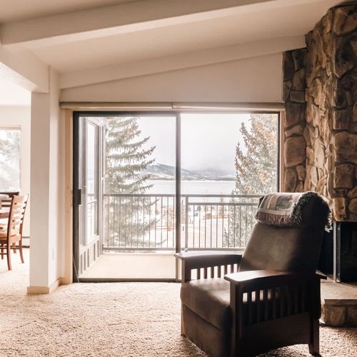 Living room with electric fireplace and balcony