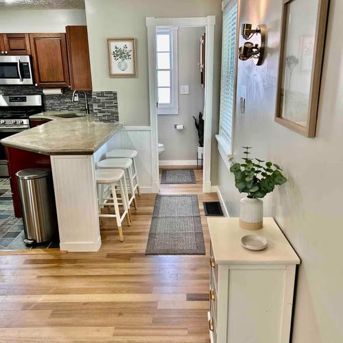 View from main entrance to the half bath and kitchen.