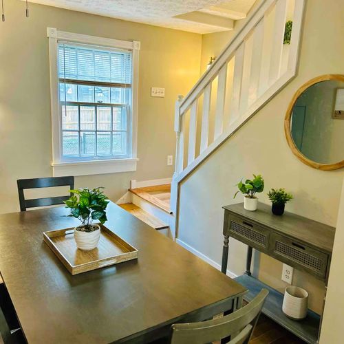 Dining area and staircase leading upstairs.