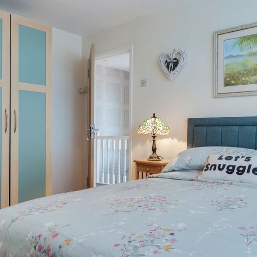 Relax in a comfortable double bed with soft linens and calming décor.