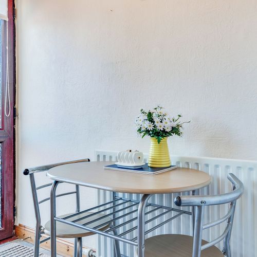 Enjoy casual meals or morning coffee in this sunny, inviting corner.