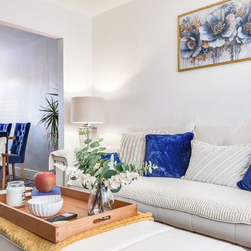 Comfortable seating and natural light make this living room your home away from home.