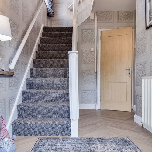 Stairway to comfort and cozy bedrooms upstairs.