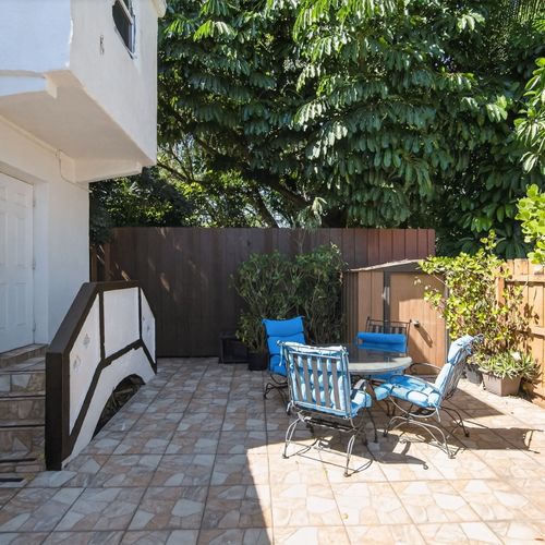 Back patio area with plenty of sitting spaces and a small ping-ping table for additional entertainment.