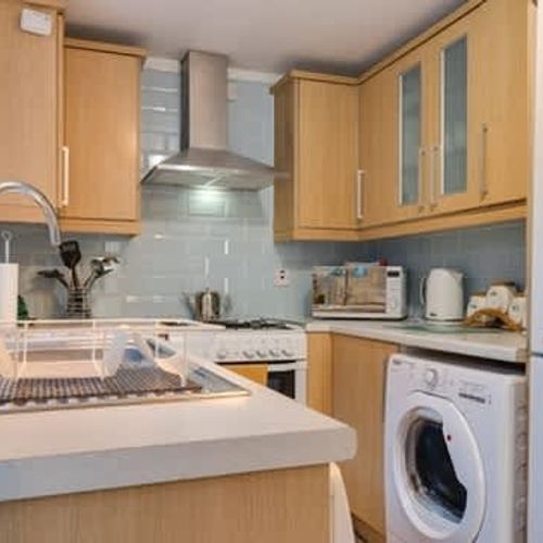 A fully equipped kitchen - including a washing machine.