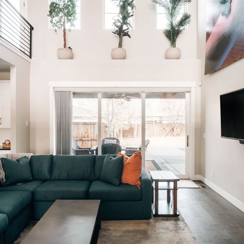 Main level living room with accordion doors that open up to back patio