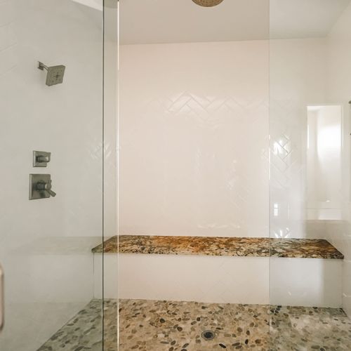 En suite bathroom has dual shower heads and additional rain shower head