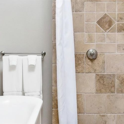 Primary en suite bathroom with soaking tub and separate shower