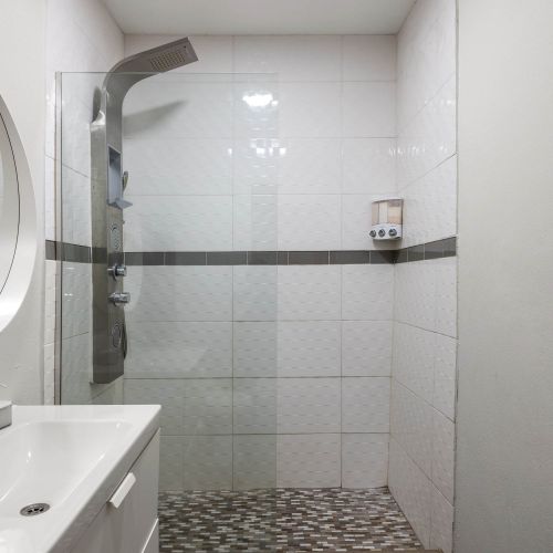 Shower area with gray tiles