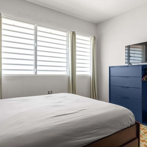 Sunlit bedroom with dresser