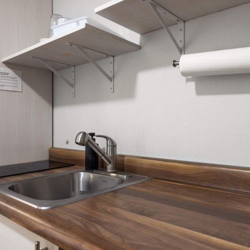 Kitchen sink and wooden shelf