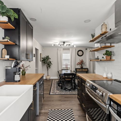 Our bright and modern kitchen with tons of counter space, open shelving, and an easy flow into the dining area for meals and memories.