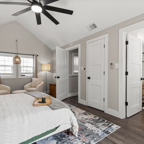 Primary suite goals, dreamy lighting, cozy seating nook, and all the space to truly unwind.