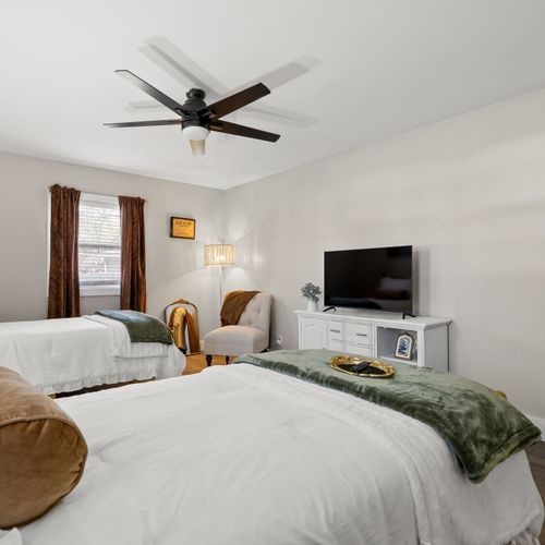 Chic gold beds, moody velvet accents, and statement curtains, basically a photo-ready sleep space.