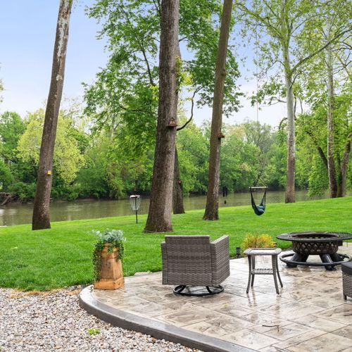 Riverside lounging at its finest — fire pit, fresh air, and front-row water views.