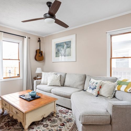 Cozy second living space with a smart TV, ceiling fan, and comfy sectional — ideal for movie nights!
