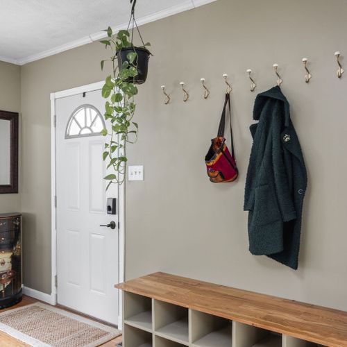 Stylish entryway with a built-in bench and hooks — the perfect drop zone for your essentials.