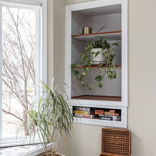 Charming built-in nook stocked with board games and puzzles for cozy nights in!