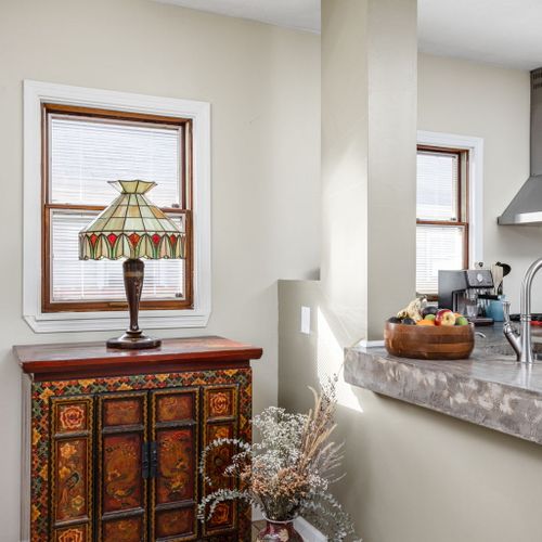 Unique vintage accents and stained glass details bring historic charm to every corner.