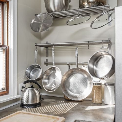 Professional-grade pot rack and shelving — a chef's dream for preparing memorable meals.