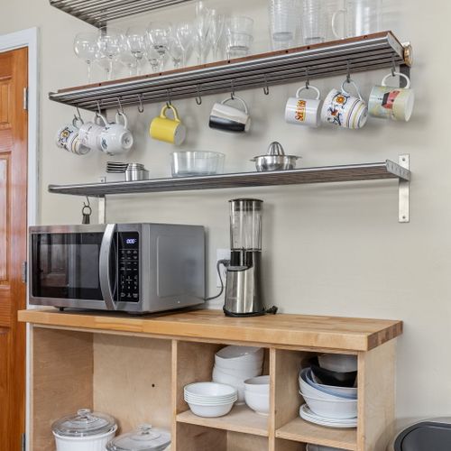 Thoughtfully designed open shelving keeps everything you need within reach — wine glasses, mugs, and dishware included.