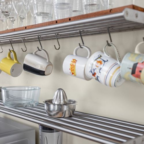 Thoughtfully designed open shelving keeps everything you need within reach — wine glasses, mugs, and dishware included.