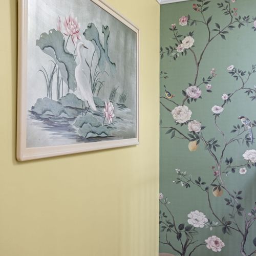 Stunning hand-painted floral mural and original artwork bring artistic flair to the upstairs landing.