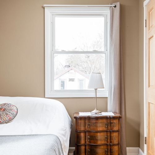 Bedroom 2 features a cozy queen bed, beautiful hardwood floors, and plenty of natural light.
