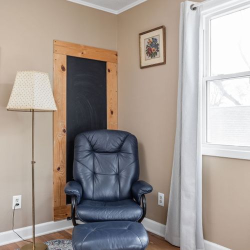 Cozy reading nook complete with a comfy leather recliner — your spot for quiet downtime.