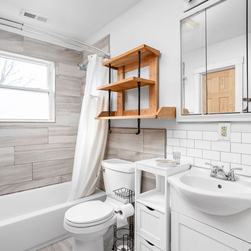 Beautifully updated full bathroom with modern subway tile, sleek finishes, and a relaxing tub-shower combo.