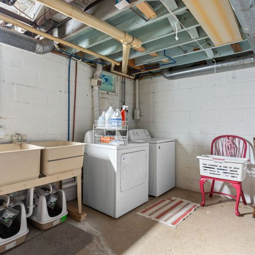 Convenient basement laundry room with full-size washer and dryer for longer stays.