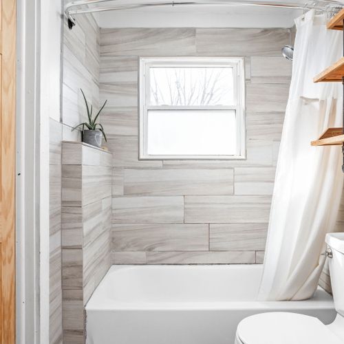 Beautifully updated full bathroom with modern subway tile, sleek finishes, and a relaxing tub-shower combo.