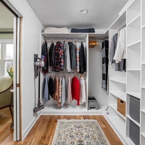 Spacious walk-in closet with custom shelving and ample hanging space for extended stays. (Clothes used for staging)