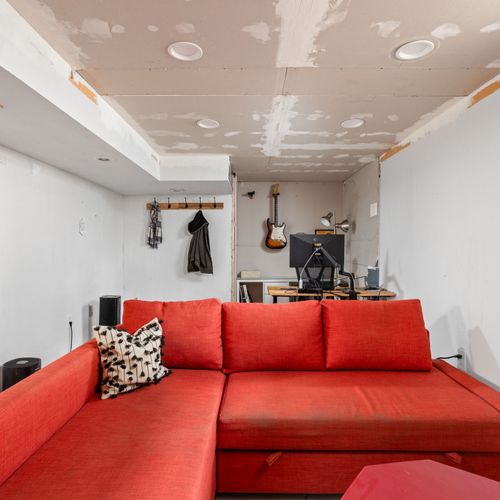 Additional basement living and workspace — versatile bonus area for relaxing or remote work.