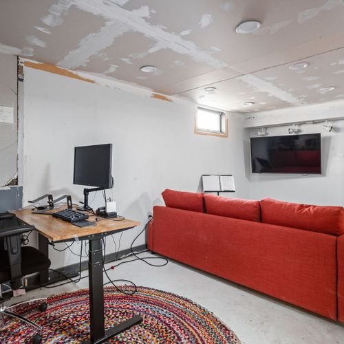 Additional basement living and workspace — versatile bonus area for relaxing or remote work.