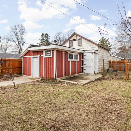 Charming exterior with multiple outdoor living spaces and a beautifully maintained private yard.