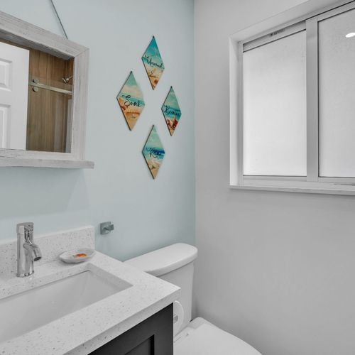 Generously sized bathroom featuring a walk in shower, updated fixtures, and a simple, functional layout.