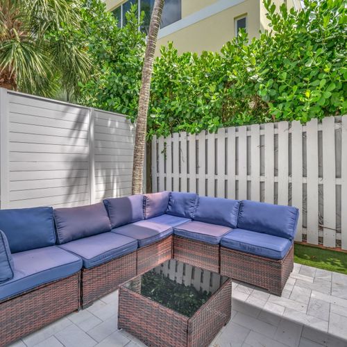 Relaxing shared patio area with comfortable seating, great for enjoying the outdoors, sipping coffee, or meeting other guests.