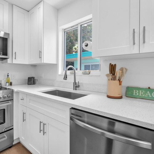 Kitchen comes stocked with utensils, plates, and basic cookware, ideal for easy cooking and everyday meals.