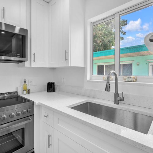 Enjoy a clean, modern kitchen featuring ample counter space, updated appliances, and a fresh, inviting ambiance.