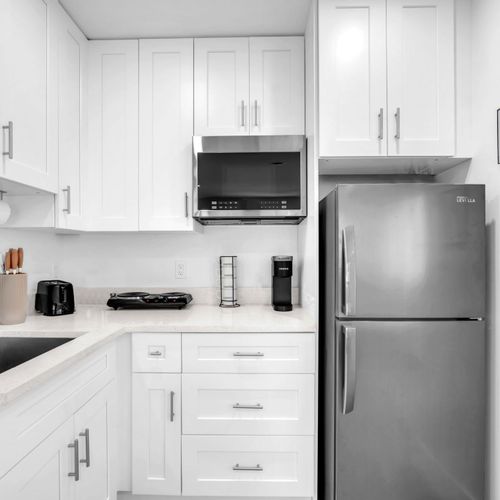 The kitchenette fully stocked with silverware, plates, and essential cookware, making it easy to prepare and enjoy meals during your stay.