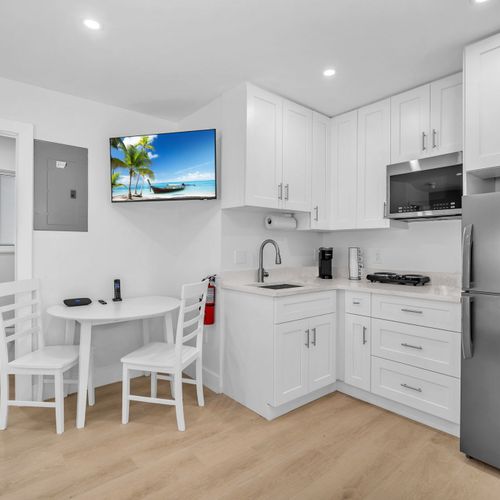 The kitchenette fully stocked with silverware, plates, and essential cookware, making it easy to prepare and enjoy meals during your stay.