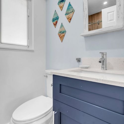 All units have tidy bathrooms with a glass-enclosed shower, updated fixtures, and a simple, functional layout.