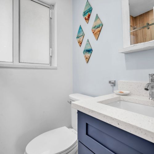 All units have tidy bathrooms with a glass-enclosed shower, updated fixtures, and a simple, functional layout.