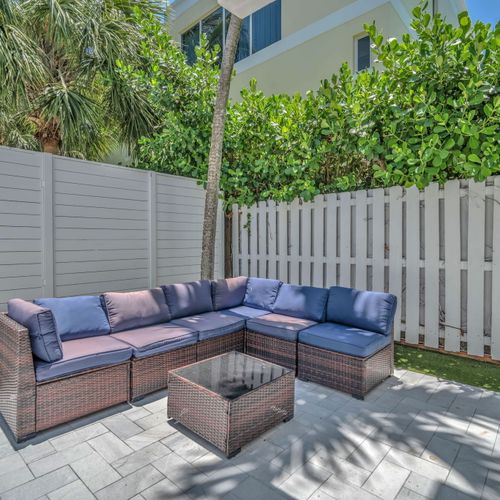 Shared backyard seating area featuring a cozy sectional sofa.
