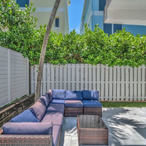 Shared backyard seating area featuring a cozy sectional sofa.